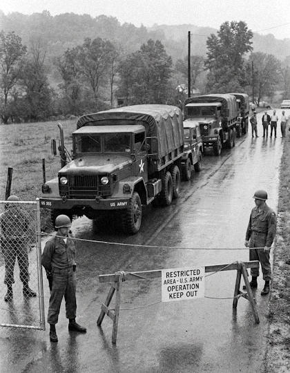 Military trucks at cordoned-off area during cover-up operation - AI-generated